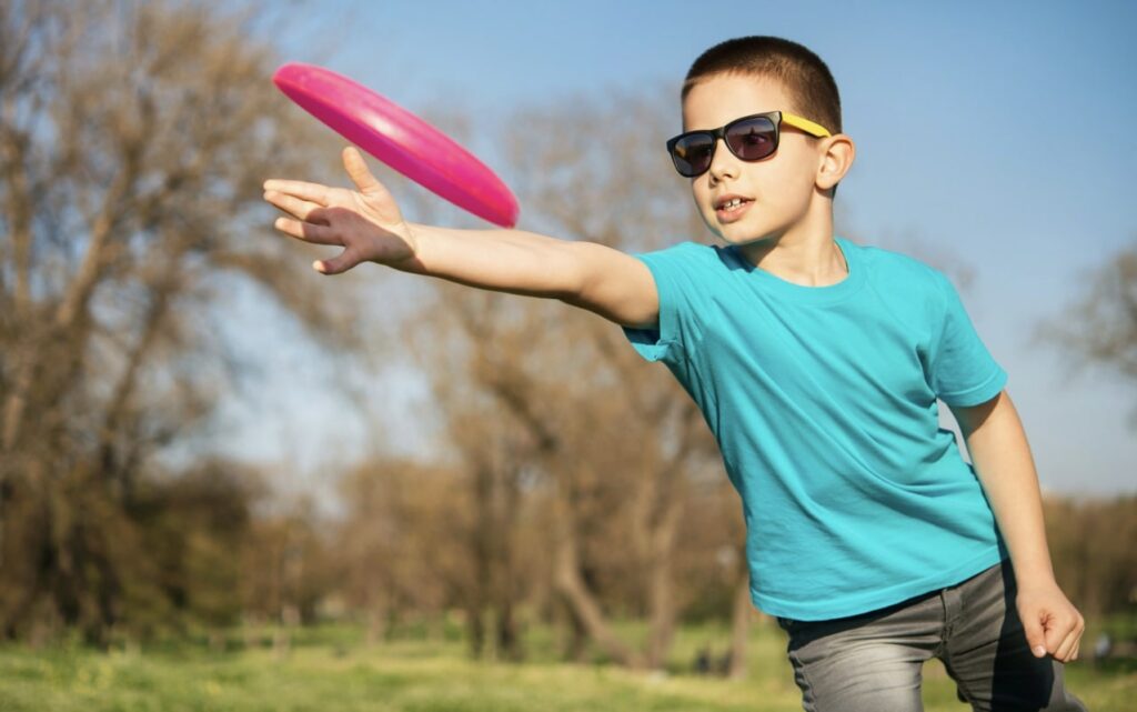 Play frisbee with your kids in the park